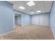 Finished basement space with neutral carpet, drop ceiling with square tiles, and two large storage closets at 248 Runyon Ct, Greenwood, IN 46142