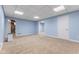 Finished basement features neutral carpet, drop ceiling and a white entry door with adjacent dehumidifier at 248 Runyon Ct, Greenwood, IN 46142