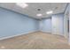 Finished basement with neutral carpet, a drop ceiling with square lights, and a white entry door at 248 Runyon Ct, Greenwood, IN 46142