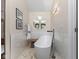 Bright bathroom with a standalone tub, neutral paint, and tiled floors and walls at 248 Runyon Ct, Greenwood, IN 46142