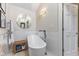 Inviting bathroom features a standalone tub, tiled accent wall and a decorative round mirror at 248 Runyon Ct, Greenwood, IN 46142