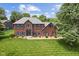 Beautiful red brick home with blue shutters and professionally landscaped lawn at 248 Runyon Ct, Greenwood, IN 46142