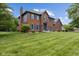Charming two-story brick home with blue shutters and a well-manicured lawn at 248 Runyon Ct, Greenwood, IN 46142