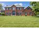 Charming two-story brick home featuring blue shutters and a well-manicured lawn at 248 Runyon Ct, Greenwood, IN 46142
