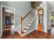 Elegant entry foyer with hardwood floors, staircase and grandfather clock at 248 Runyon Ct, Greenwood, IN 46142