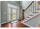 Bright entryway with hardwood floors, staircase and decorative glass front door at 248 Runyon Ct, Greenwood, IN 46142
