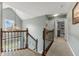 Bright hallway featuring neutral tones, wood and iron railing, and natural light from a window at 248 Runyon Ct, Greenwood, IN 46142