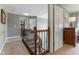 Hallway with neutral walls, carpet and wood/wrought iron banister overlooking lower level at 248 Runyon Ct, Greenwood, IN 46142