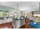 Bright eat-in kitchen features gray cabinetry, a center island with countertop seating, and backyard access at 248 Runyon Ct, Greenwood, IN 46142