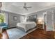 Comfortable primary bedroom with tray ceiling, hardwood floors, and ensuite bathroom access at 248 Runyon Ct, Greenwood, IN 46142