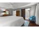 Spacious bedroom features wood floors, a tray ceiling, and an attached bathroom with barn door at 248 Runyon Ct, Greenwood, IN 46142