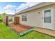 Cozy backyard features a small garden area, wood fence, and a convenient back door entrance at 2740 Braxton Dr, Indianapolis, IN 46229