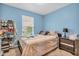 Cozy bedroom with light blue walls, comfortable bed, and window with natural light at 2740 Braxton Dr, Indianapolis, IN 46229
