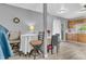 Dining area features stylish table and chairs, wood floors, and sliding glass doors to the backyard at 2740 Braxton Dr, Indianapolis, IN 46229