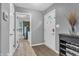 Welcoming foyer with white front door, wood-look floors, and view into the adjacent rooms at 2740 Braxton Dr, Indianapolis, IN 46229