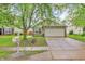 Beautiful exterior of home with a two-car garage, mature tree, and an inviting curb appeal at 2740 Braxton Dr, Indianapolis, IN 46229
