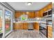 Bright kitchen with light wood cabinets, stainless steel appliances, and a view to the backyard at 2740 Braxton Dr, Indianapolis, IN 46229