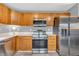 Modern kitchen with stainless steel appliances, plentiful wood cabinetry, and sleek countertops at 2740 Braxton Dr, Indianapolis, IN 46229