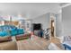 Open-concept living room features modern gray walls, wood flooring, and neutral furniture with colorful accent pillows at 2740 Braxton Dr, Indianapolis, IN 46229