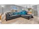 Spacious living room with large windows, grey sofa with blue pillows, and durable floors at 2740 Braxton Dr, Indianapolis, IN 46229