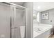 Bright bathroom featuring a tub, shower, and a window with natural light at 2802 Singletree Dr, Indianapolis, IN 46234
