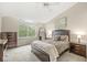Comfortable bedroom with an overhead fan, natural light, and warm neutral color palette at 2802 Singletree Dr, Indianapolis, IN 46234