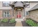 Charming front entrance with a red door, brick facade, and well-maintained landscaping creating curb appeal at 2802 Singletree Dr, Indianapolis, IN 46234