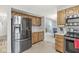 Efficient kitchen layout with stainless steel appliances and a convenient pass-through to the living area at 2802 Singletree Dr, Indianapolis, IN 46234