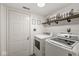 Well-organized laundry area featuring white washer and dryer with decorative shelving at 2802 Singletree Dr, Indianapolis, IN 46234