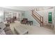 Bright living room with a view of the staircase and dining room featuring cohesive color palette at 2802 Singletree Dr, Indianapolis, IN 46234