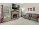 Bright living room boasts a brick fireplace, large windows and plush seating at 2802 Singletree Dr, Indianapolis, IN 46234