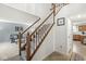 Inviting staircase with wood railings and white spindles leading to the upper level of the home at 2802 Singletree Dr, Indianapolis, IN 46234