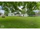 Spacious backyard with lush green grass and a detached garage/shed at 2840 W 12Th St, Anderson, IN 46011