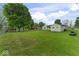 Large, grassy backyard with mature trees and a detached garage/shed at 2840 W 12Th St, Anderson, IN 46011