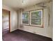 A room with two windows, neutral walls, and dated carpet awaiting personalization at 2840 W 12Th St, Anderson, IN 46011