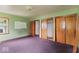Bedroom with green walls, carpeted floors, and wood trim and doors at 2840 W 12Th St, Anderson, IN 46011