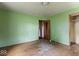 Bedroom with hardwood floors, green walls, and wood trim at 2840 W 12Th St, Anderson, IN 46011