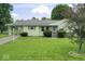 Charming single-story home with a well-manicured lawn and attached carport at 2840 W 12Th St, Anderson, IN 46011