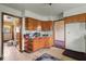 An outdated kitchen featuring wood cabinets and a worn floor with multiple entry ways at 2840 W 12Th St, Anderson, IN 46011