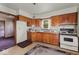Kitchen with wood cabinets and a white range stove in need of an upgrade at 2840 W 12Th St, Anderson, IN 46011