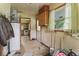 View of a utility room with cabinets, water heater, and window at 2840 W 12Th St, Anderson, IN 46011