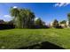 Expansive backyard with lush green lawn and mature trees offers privacy at 3059 Black Forest Ln, Indianapolis, IN 46239
