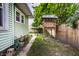 Backyard featuring a small playhouse, green siding, and a wood fence at 309 N Riley Ave, Indianapolis, IN 46201
