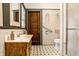 Bathroom featuring mosaic floors, a wooden vanity, and grab bars at 309 N Riley Ave, Indianapolis, IN 46201