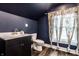 Charming bathroom featuring dark blue walls, modern sink and floral curtains at 309 N Riley Ave, Indianapolis, IN 46201