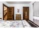 Bedroom featuring hardwood floors, white walls, dresser, and two doors at 309 N Riley Ave, Indianapolis, IN 46201