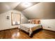 Cozy bedroom with hardwood floors and natural light from the large window at 309 N Riley Ave, Indianapolis, IN 46201