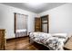 Bedroom featuring hardwood floors, window with curtain, and a single bed at 309 N Riley Ave, Indianapolis, IN 46201