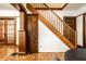 Hardwood floors and wood trim highlight this hallway with staircase and closet at 309 N Riley Ave, Indianapolis, IN 46201