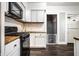 Modern kitchen features white cabinets, wood countertops, and stainless steel appliances at 309 N Riley Ave, Indianapolis, IN 46201